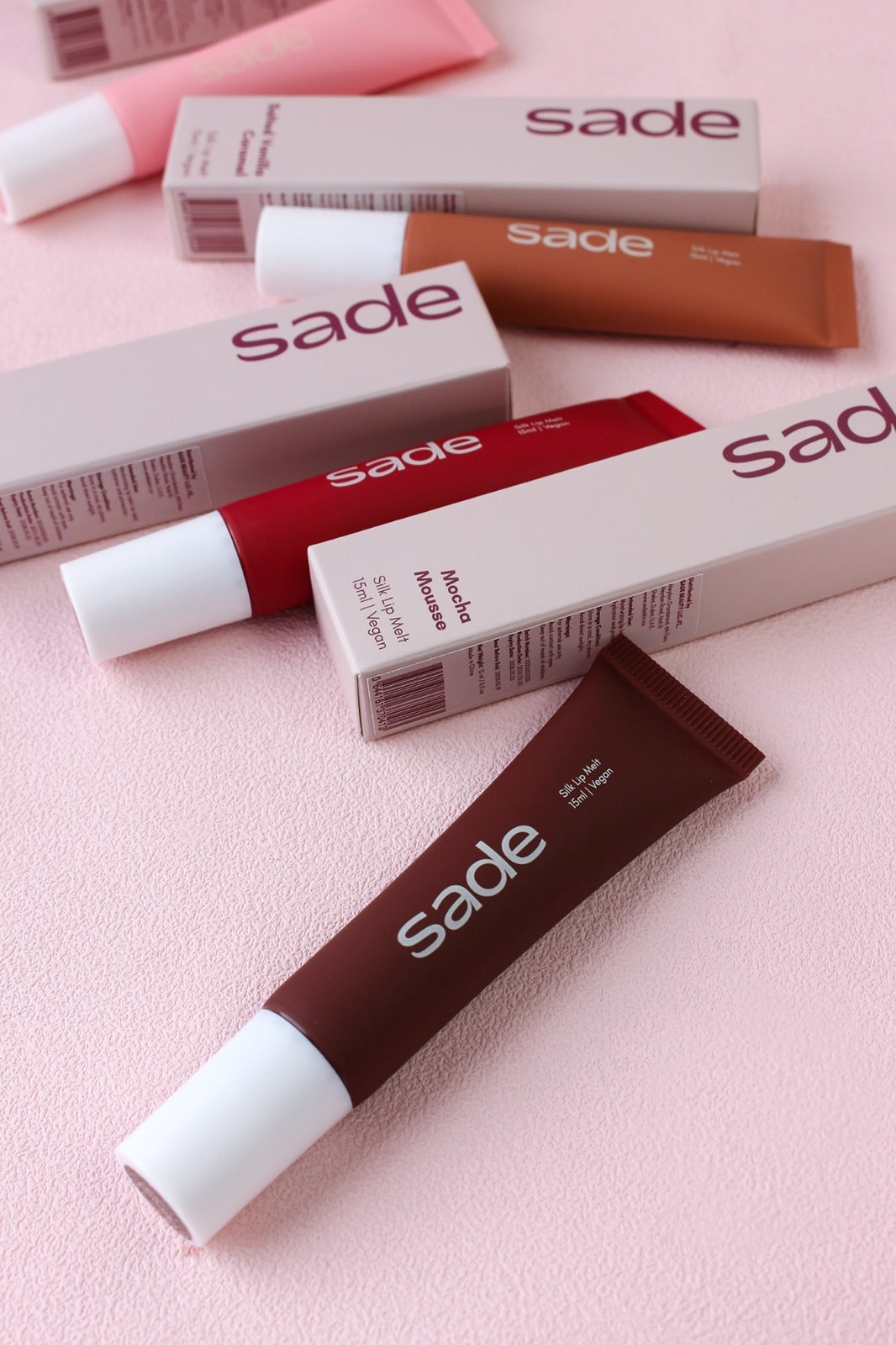 Silk Lip Melt — all four shades on pink
